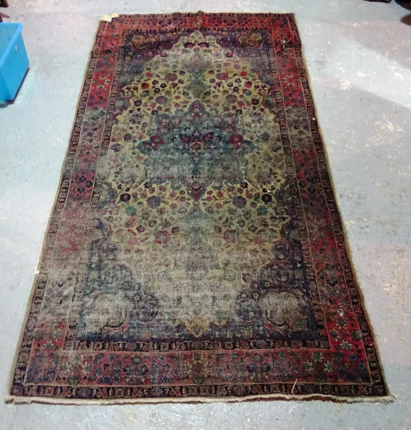 A Persian long rug with stretched oval medallion within plum main border, (a.f.) 247cm x 132cm