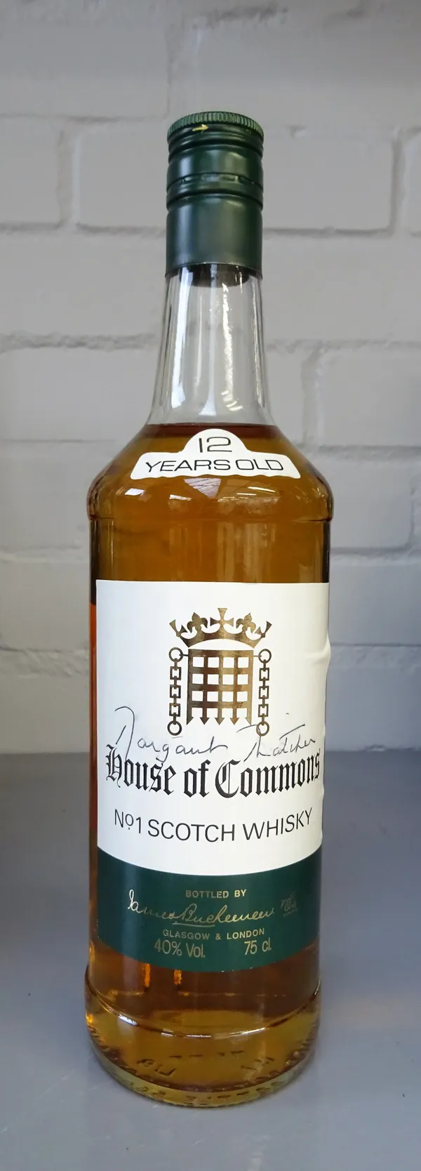 A bottle of twelve year old 'House of Commons' whisky, signed by Margaret Thatcher, boxed.