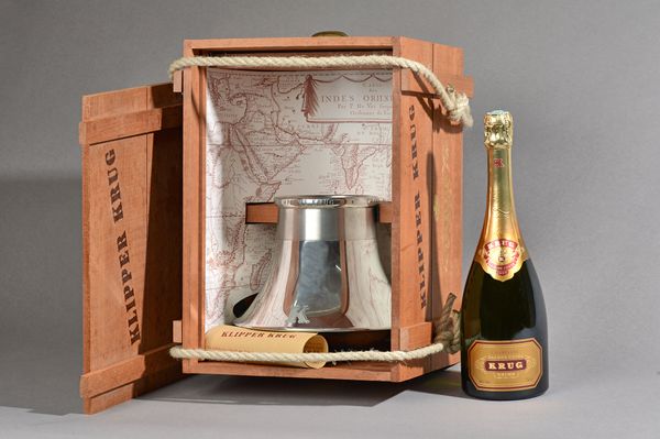 One bottle of Krug champagne with a 'klipper krug' or champagne bucket, presentation cased. Illustrated