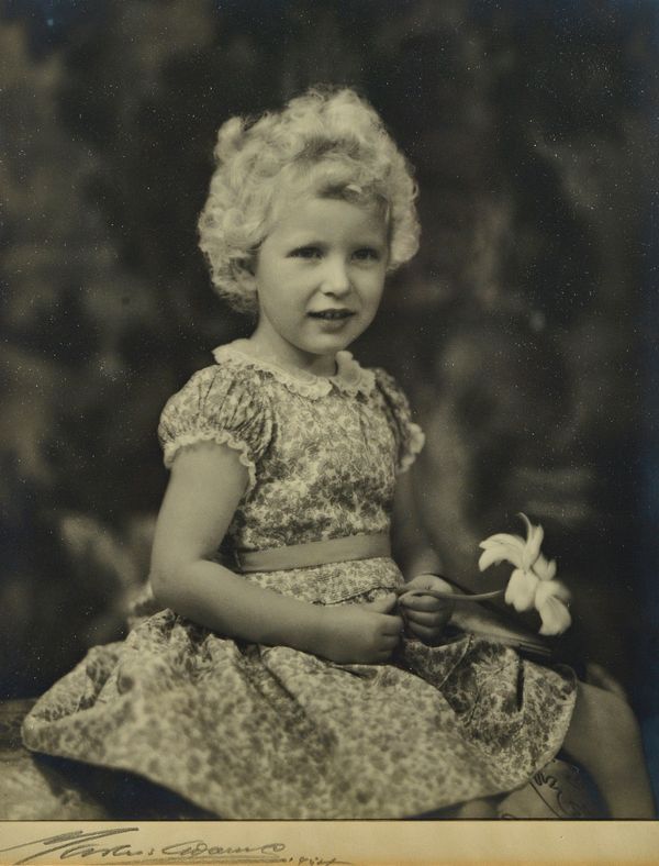 MARCUS ADAMS (1875 -1959)  Princess Anne on her fourth birthday, August 15th, 1954:   black and white photo. portrait shows her wearing a Liberty prin