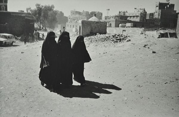 NICK ROSS  (Contemporary)  Three Middle Eastern Ladies in a cityscape, ca. 2008:  platinum print, 30cm x 45cm, unframed.  DDS