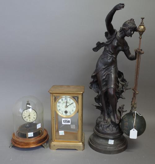 A French brass cased four glass mantel clock with faux mercury pendulum, 22.5cm high, an early 20th century timepiece with suspended spherical pendulu