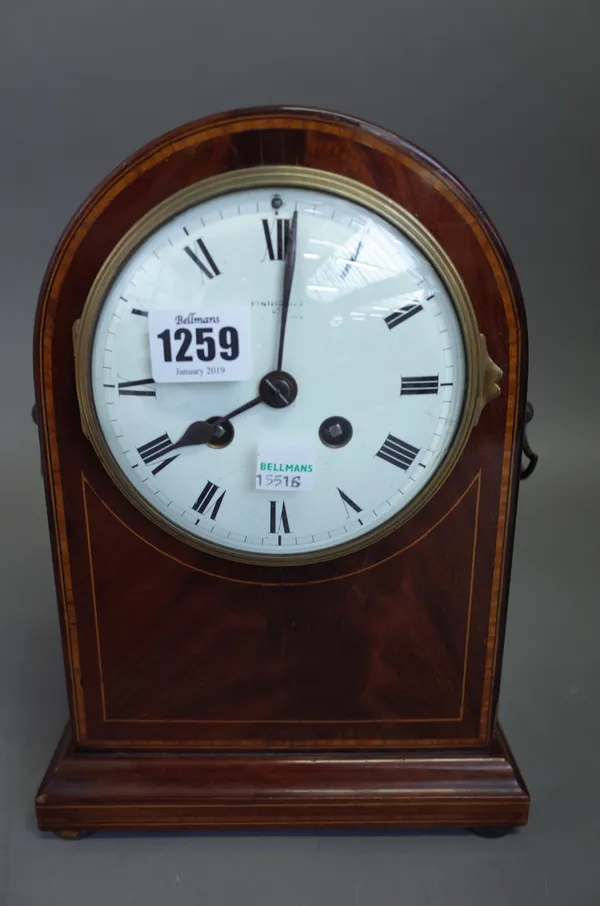 An Edwardian mahogany cased mantel clock of dome form with a white enamel dial and two train movement (26cm high) and a modern mantel clock with West