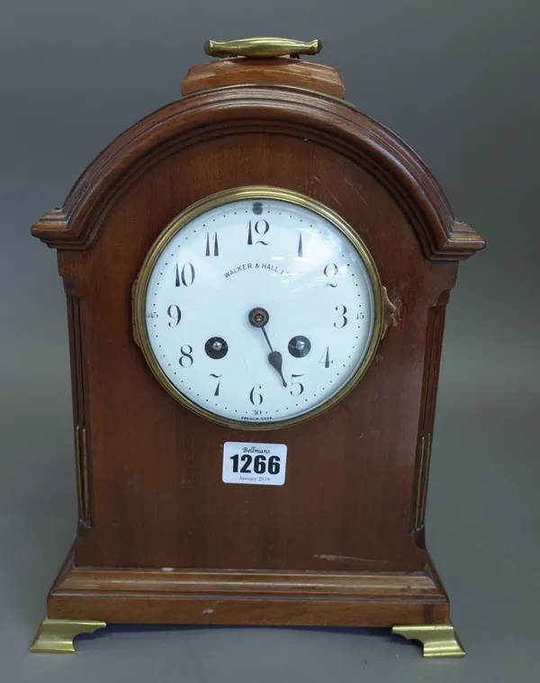A mahogany cased arch top mantel clock, late 19th century, brass handle above the white enamel dial detailed 'WALKER & HALL LTD', enclosing a French t