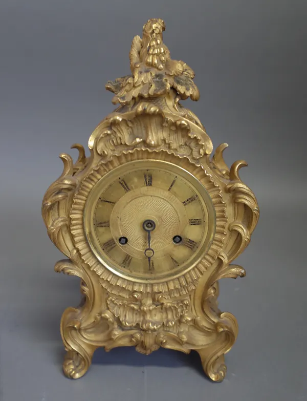 A French ormolu mantel clockIn the Louis XV style, circa 1850The case of shaped outline, cast with foliage and flowers, with a pierced grille to each