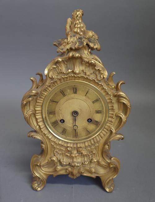 A French ormolu mantel clockIn the Louis XV style, circa 1850The case of shaped outline, cast with foliage and flowers, with a pierced grille to each