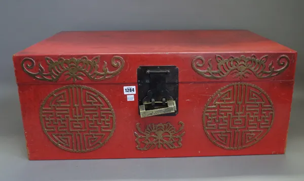 A modern Chinese papier mache lacquered chest, red painted with Chinese gilt symbols against a rectangular body, 74cm wide.