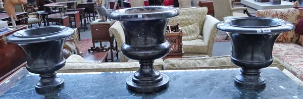 A pair of modern marble urns, 31cm high and one larger similar marble urn, 40cm high. (3)
