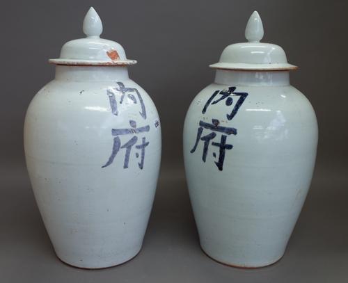 A pair of modern Chinese pottery vases and covers decorated with blue script against a white ground, 53cm high. (2)
