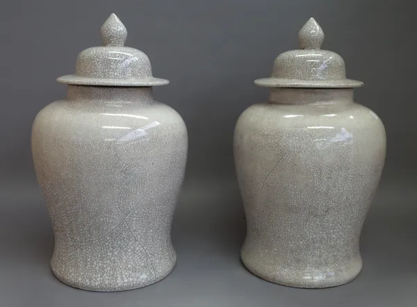 A pair of modern Chinese pottery vases and covers decorated with crackle glaze against a baluster ground, 48cm high. (2)