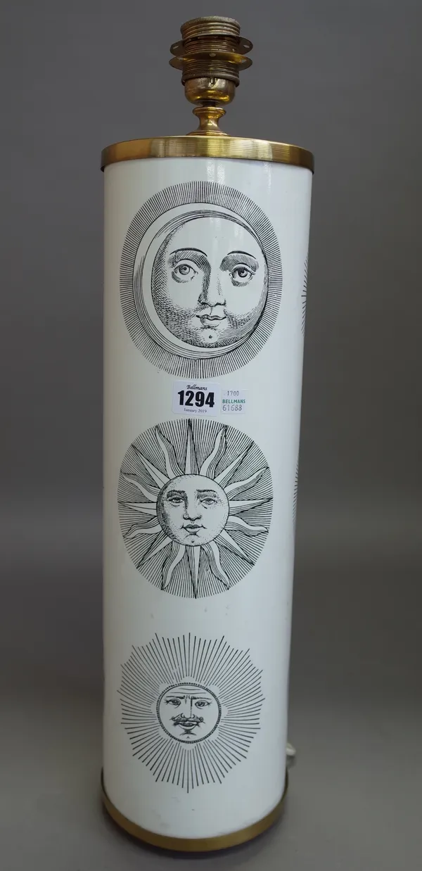 A Fornasetti table lamp decorated with sun motifs against a cylindrical white metal and gilt body, 51.5cm high excluding fitment, 1700