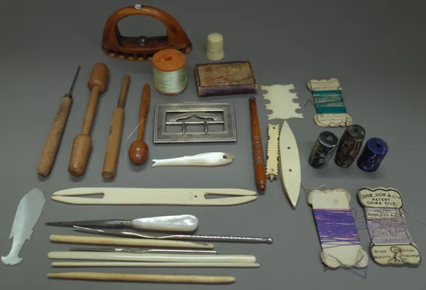 A quantity of late 19th century ivory sewing collectables, an ivory folding toothpick, three hardstone seals, and a silver belt buckle, (qty).  1400,