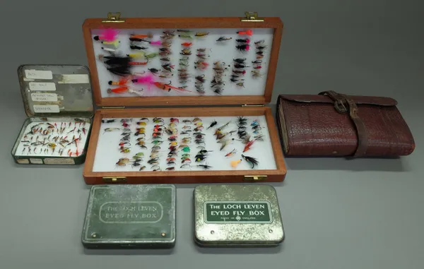 A Richard Wheatley wooden fly box with aprox 160 flies, three Wheatley 'Loch Leven eyes' fly boxes and an Army & Navy leather fly wallet.