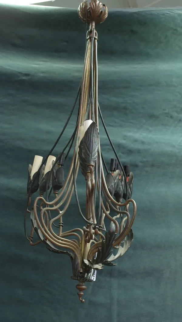 An Art Nouveau nine branch gilt metal chandelier in the manner of WAS Benson, of foliate cast tubular form, 95cm high and a wrought iron and copper mo