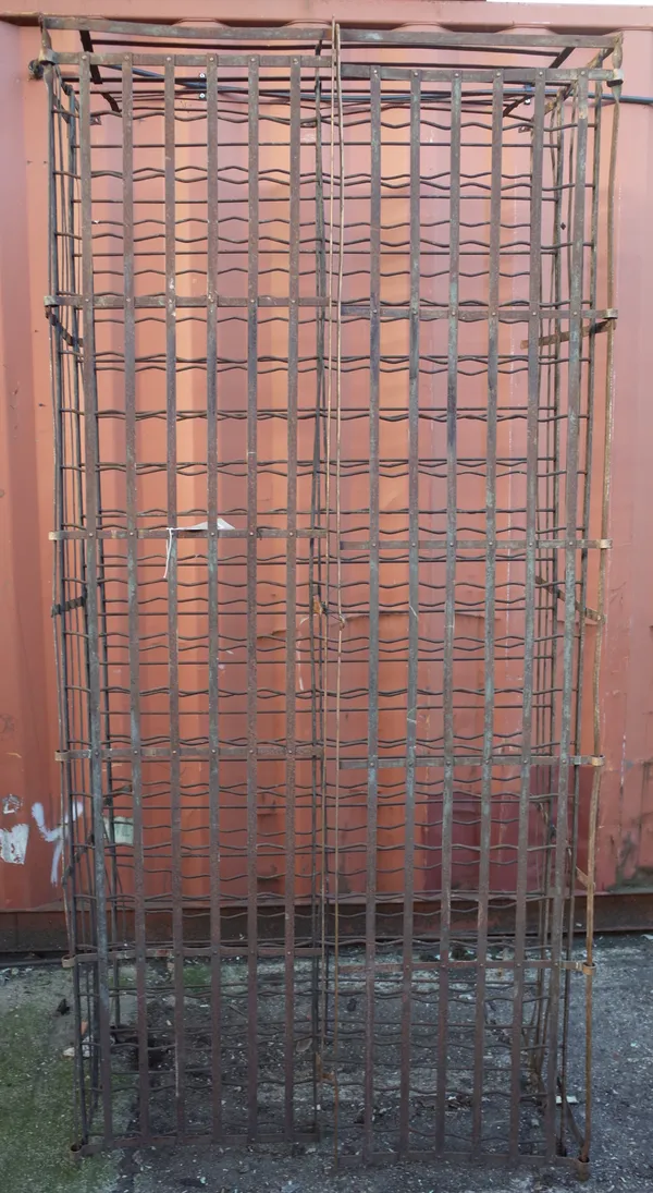 A four hundred bottle wrought iron wine rack, with hinged front doors, 220cm high x 104cm wide x 56cm deep.