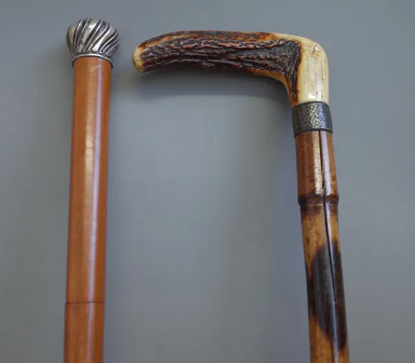 A Victorian malacca and silver mounted walking cane sword stick (88.5cm) and a Victorian bamboo weighted walking stick with horn handle (88.5cm), (2).