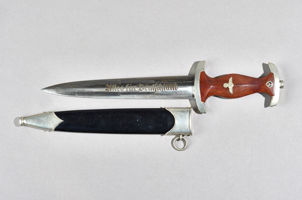A German World War II SA dagger, the double edged steel blade detailed 'ALLES FUR DEUTSCHLAND', crossguard hilt, wooden shaped handle and lacquered me