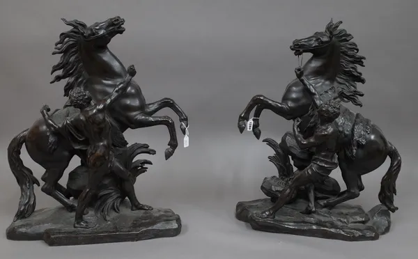 After Coustou, a pair of Victorian bronze Marly Horses, each modelled and cast on a naturalistic base, unsigned, 62cms high. (2)
