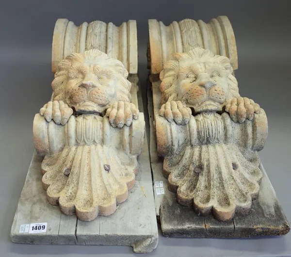 A pair of composite stone corbels, each with lion head mask mounted on a pine plinth, corbel is 66cm high, (2).