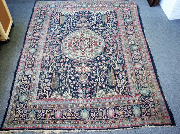 A Persian blue ground carpet, possibly Tabriz, central medallion with Cypress tree surround, approximately 379cm x 275cm (worn).