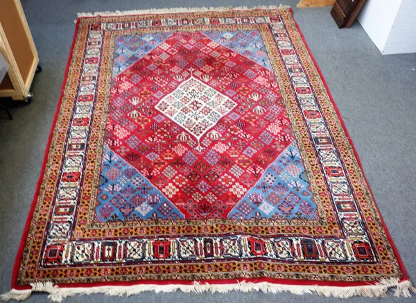 A Joshaghan carpet, Persian, the madder field with an ivory diamond, matching indigo spandrels, all with diamond flower bursts, ivory palmette vine bo