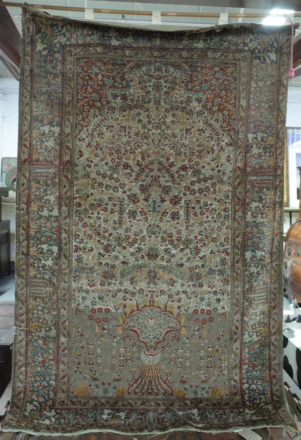 A Kashan Souf prayer rug, Persian, the ivory mihrab with a vase of abundantly floral sprays, a madder arch above a pale indigo floral border, 210cm x
