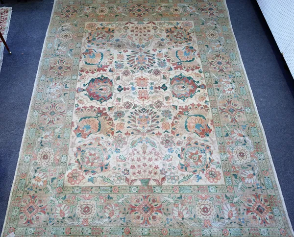 A modern Egyptian carpet, the ivory field with an allover bold palmette and flower design, beige flower head border, 397cm x 303cm.