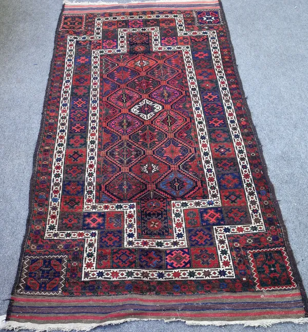 A Persian tribal rug with multicoloured repeating gul design within stepped white borders, flatweave ends, 243cm x 124cm.  4852
