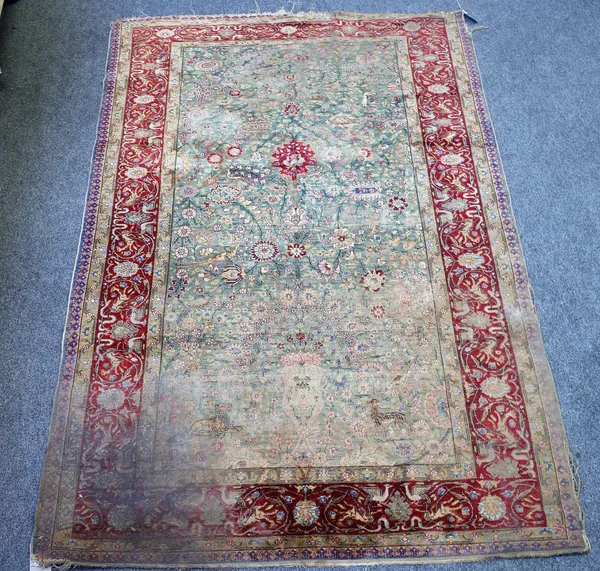 An antique rug, possibly a Kashan Souf, the blue green main field with all over polychrome floral design and decorative motifs of phoenix, stag, tiger