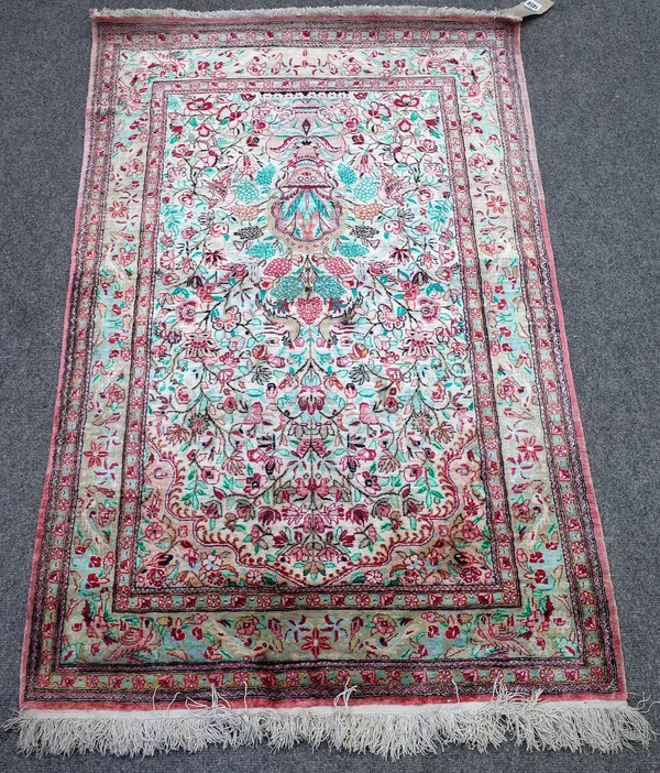 A Persian part silk prayer rug, white field with bird and floral design under a mihrab, 131cm x 83cm.4856