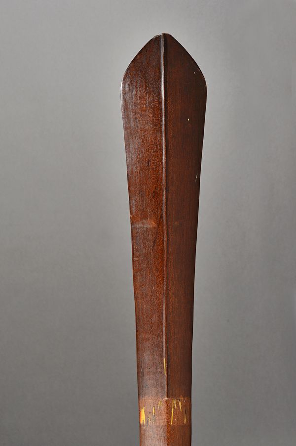 A Solomon Islands hardwood club of oval section, with raised medial ridge and signs of previous banded decoration, 130cm. Illustrated