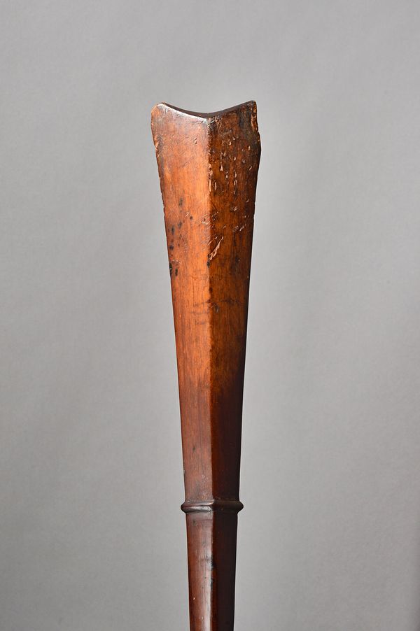 A Tongan hardwood war club, with lozenge shaped paddle and indistinctly carved circular tapering grip, 107cm. Illustrated