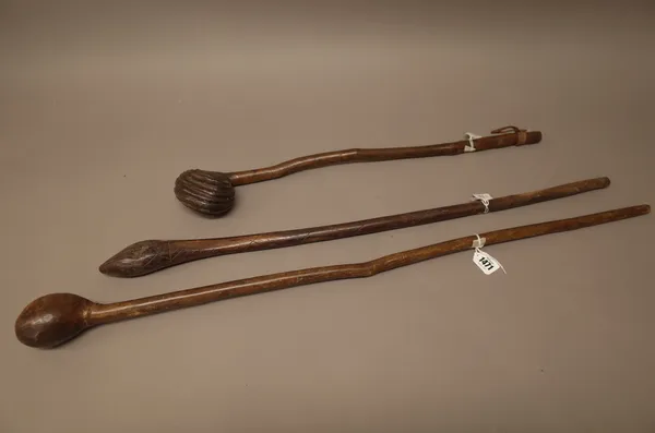 Two East African hardwood clubs, with bulbous heads and tapering cylindrical handles (86cm) and an Australian club with bulbous tapering head and carv