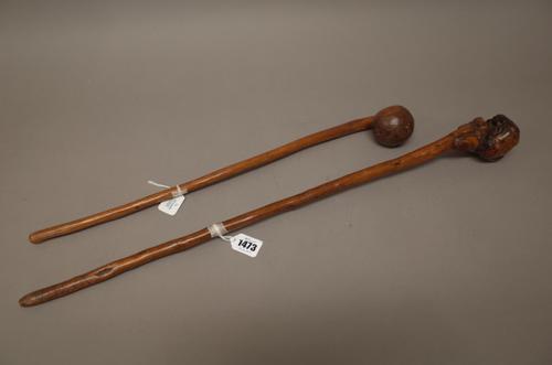 Two East African hardwood clubs, one with naturalistic root form head, the other of bulbous carved form, both with cylindrical tapering handles, (64cm