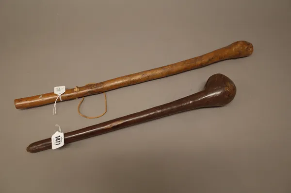 Two East African hardwood clubs, each of naturalistic form with bulbous head and tapering cylindrical handle, the longest 61cm, (2).