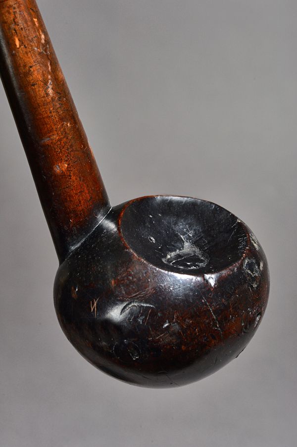 An African Zulu hardwood knobkerry (knobkierie), the bulbous head with two circular concave recesses, over a tapering cylindrical shaft, 54cm. Illustr