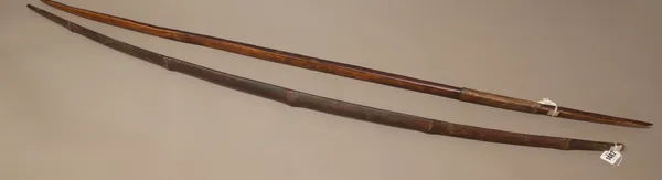 A hardwood and leather bound bow (141cm), possibly New Guinea and a bamboo bow (135cm), (2)