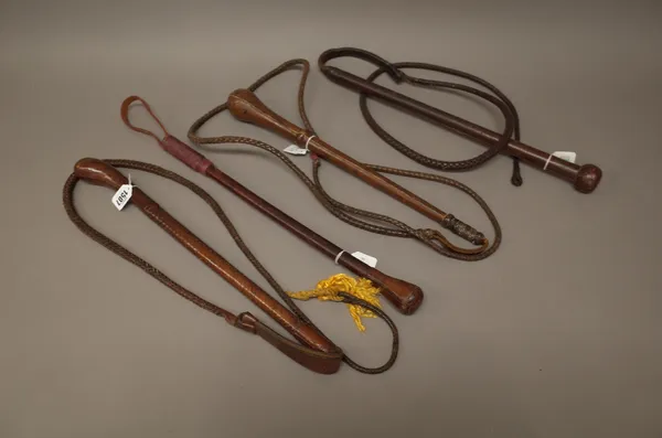 Three leather bull whips each with weighted terminals and braided leather whips and one further weighted leather shot whip, (4).