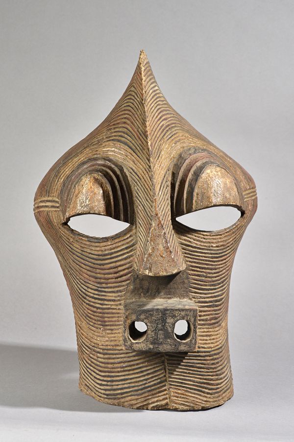 Central Africa, Songye tribe, Kifwebe mask, polychrome painted carved wood with central crest, 54cm high. Illustrated