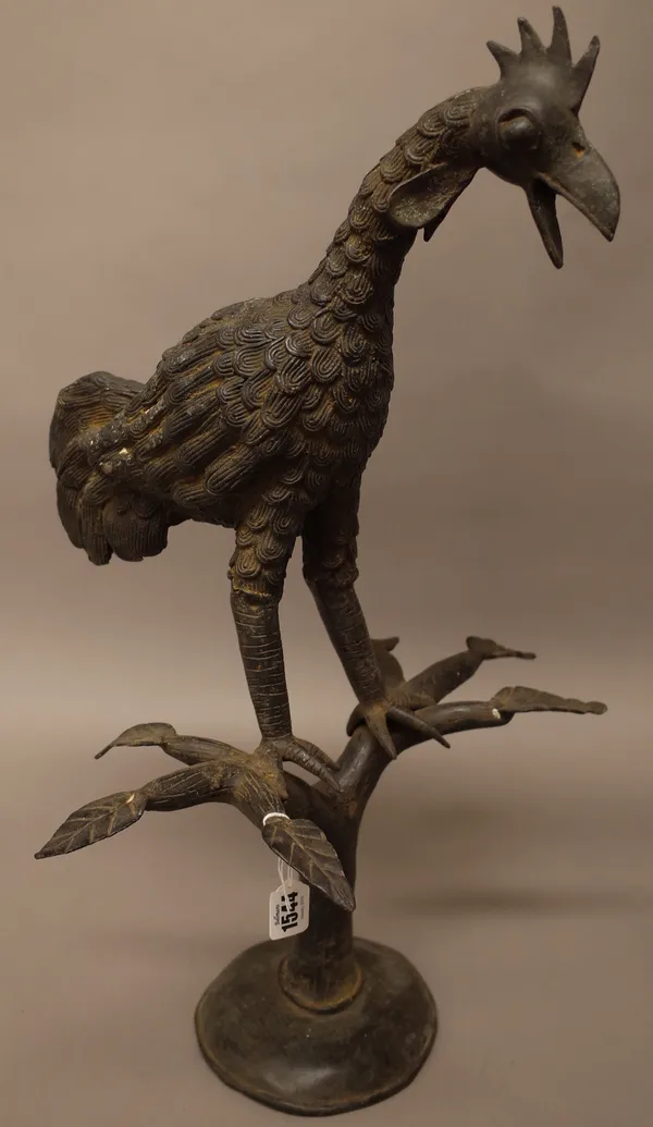 An African bronze cockerel, modelled on a leafy branch and domed foot, 65cm high.