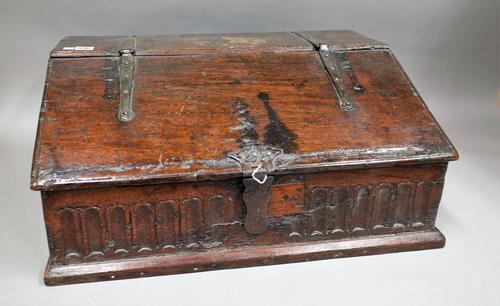 A 17th century oak slope front bible box with carved front panel, 64cm wide x 30cm high.
