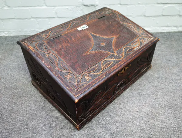 A 19th century carved oak slope front bible box, 53cm wide x 25cm high.