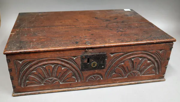 An 18th century oak bible box, with carved front panel, 60cm wide x 20cm high.   1033