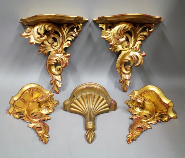A pair of Rococo revival gilt wood wall brackets, 31cm wide x 33cm high, a matching smaller pair, 21cm wide x 22cm high and another, 22cm wide x 22cm