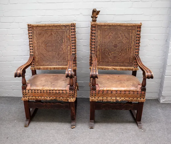 A pair of 18th century Spanish parcel gilt and walnut square back open arm throne chairs on sleigh feet, 64cm wide x 113cm high (2).