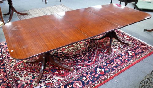A Regency style mahogany D-end extending dining table, on eight downswept supports, with one extra leaf, 102cm wide x 184cm long x 245cm long extended