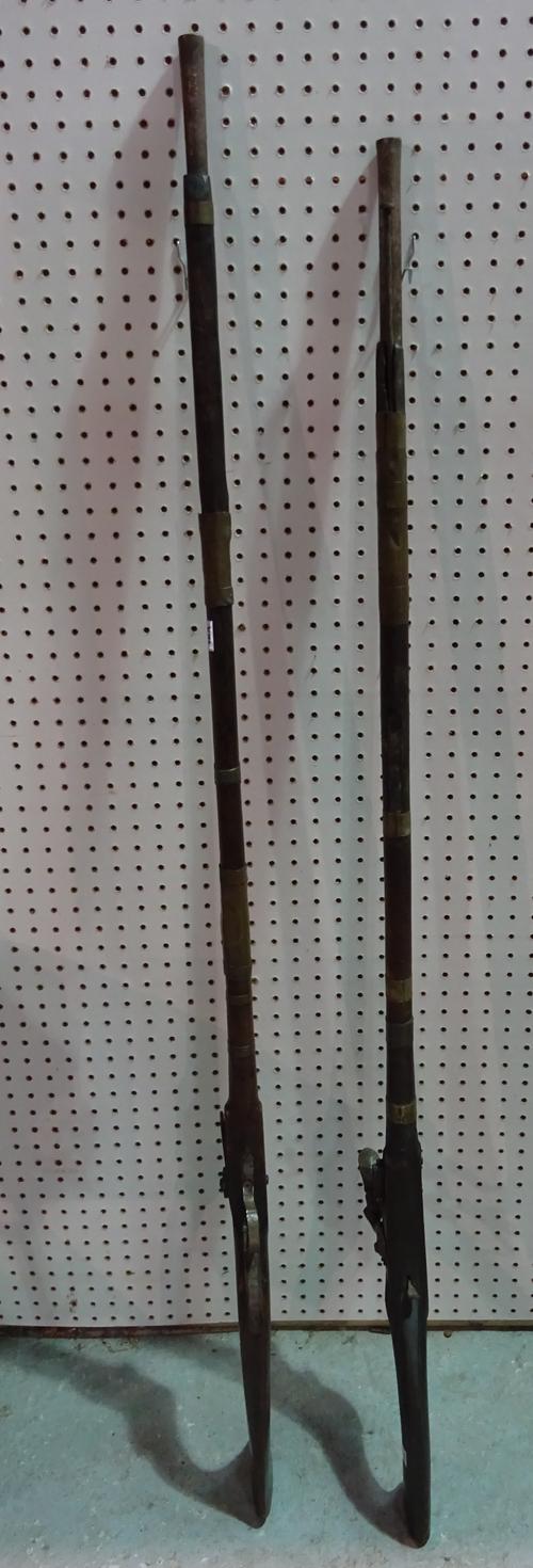 A similar pair of early 20th century Eastern matchlock rifles, converted to percussion action (2).  CAB