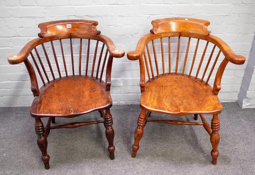 A pair of late 19th century oak and elm tub back smoker's bow armchairs, on turned supports, 65cm wide x 82cm high, (2).