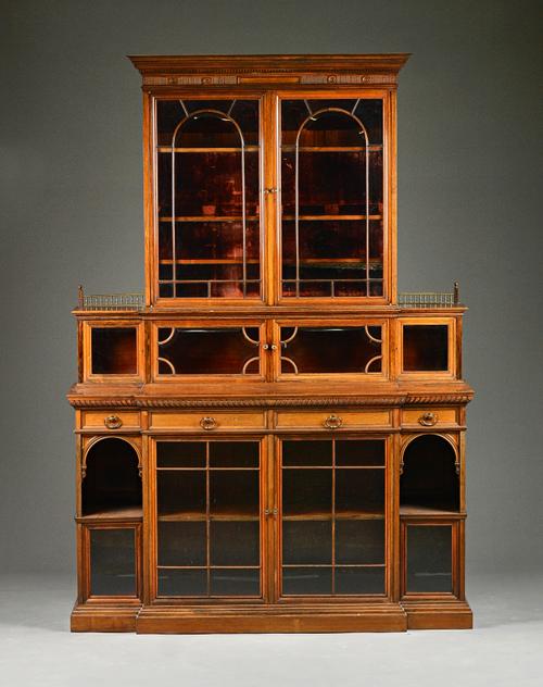 HOWARD & SON BERNERS STREET, LONDON; a late 19th century rosewood breakfront bookcase cabinet with an arrangement of bevelled glass astragal glazed cu