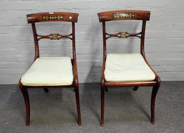 A set of six Regency brass inlaid faux rosewood dining chairs with bull's eye waist rail on sabre supports, 45cm wide x 83cm high. (6).